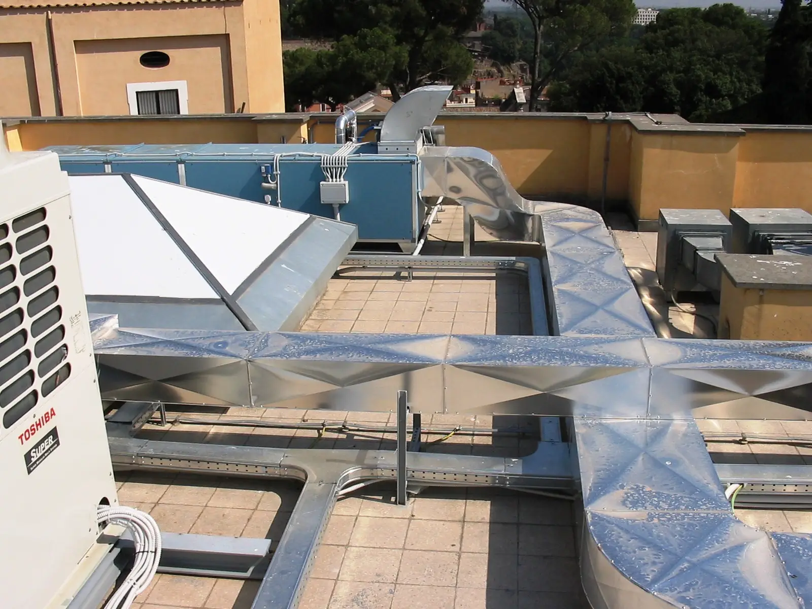 Copertura del palazzo con canalizzazioni e unità impiantistiche sul lastrico
