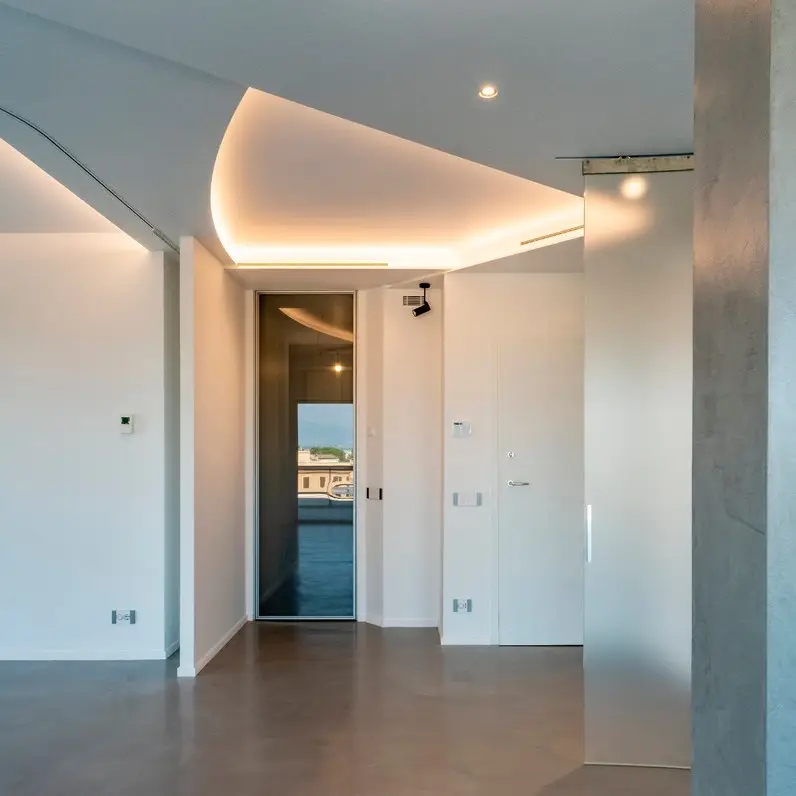 Disimpegno con controsoffitto curvo e diffusore lineare integrato